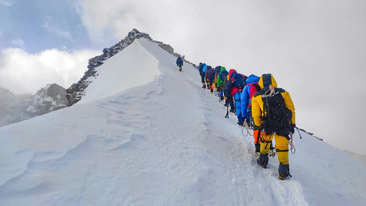 Trekkers climbing a challenging Himalayan expedition route.