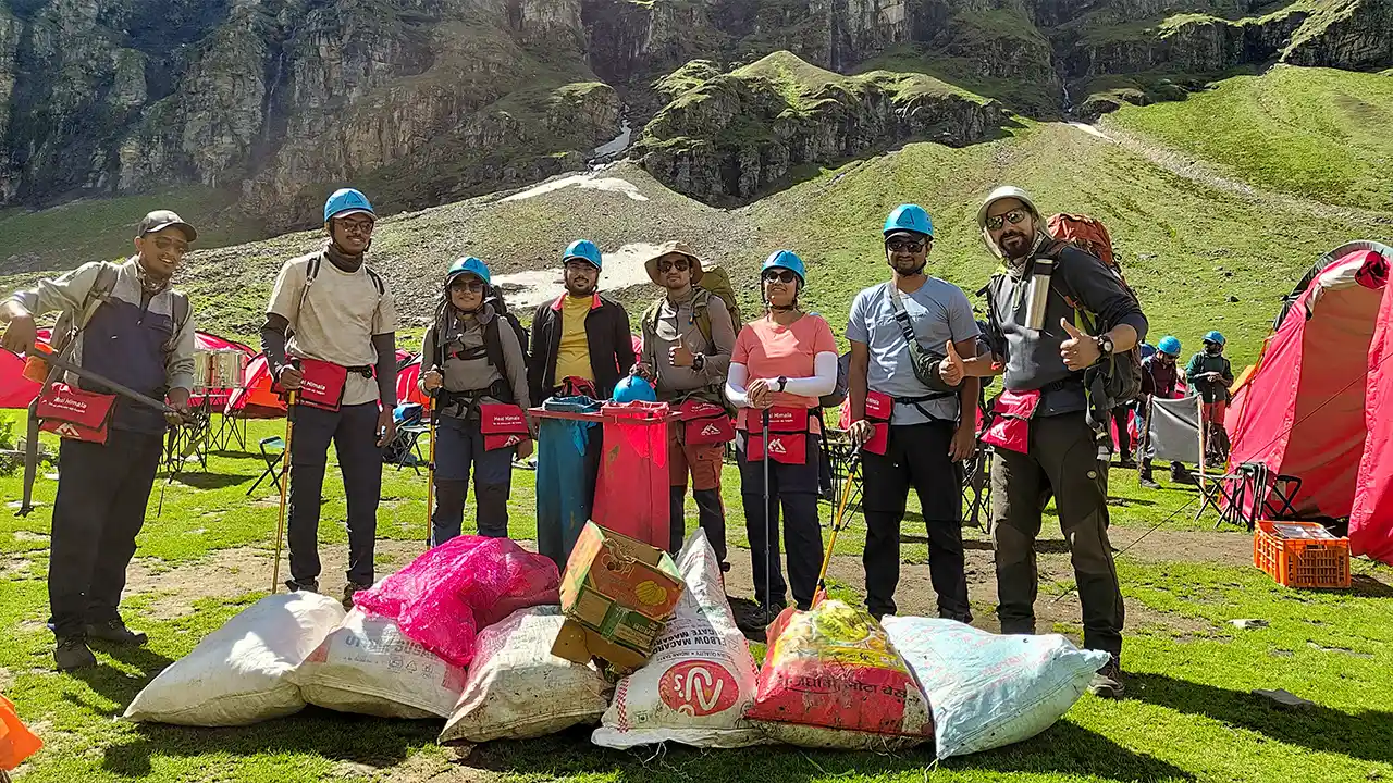Trek The Himalayas team collecting waste at mountain campsite promoting cleanliness, sustainable tourism, and eco-friendly trekking in the Himalayas, indian hike