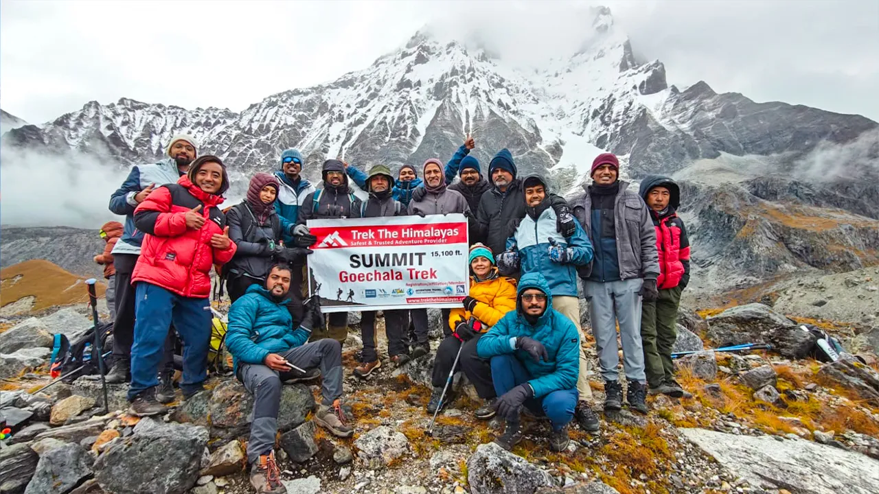 Trekkers celebrating Goechala Trek summit at 15,100 ft with Trek The Himalayas