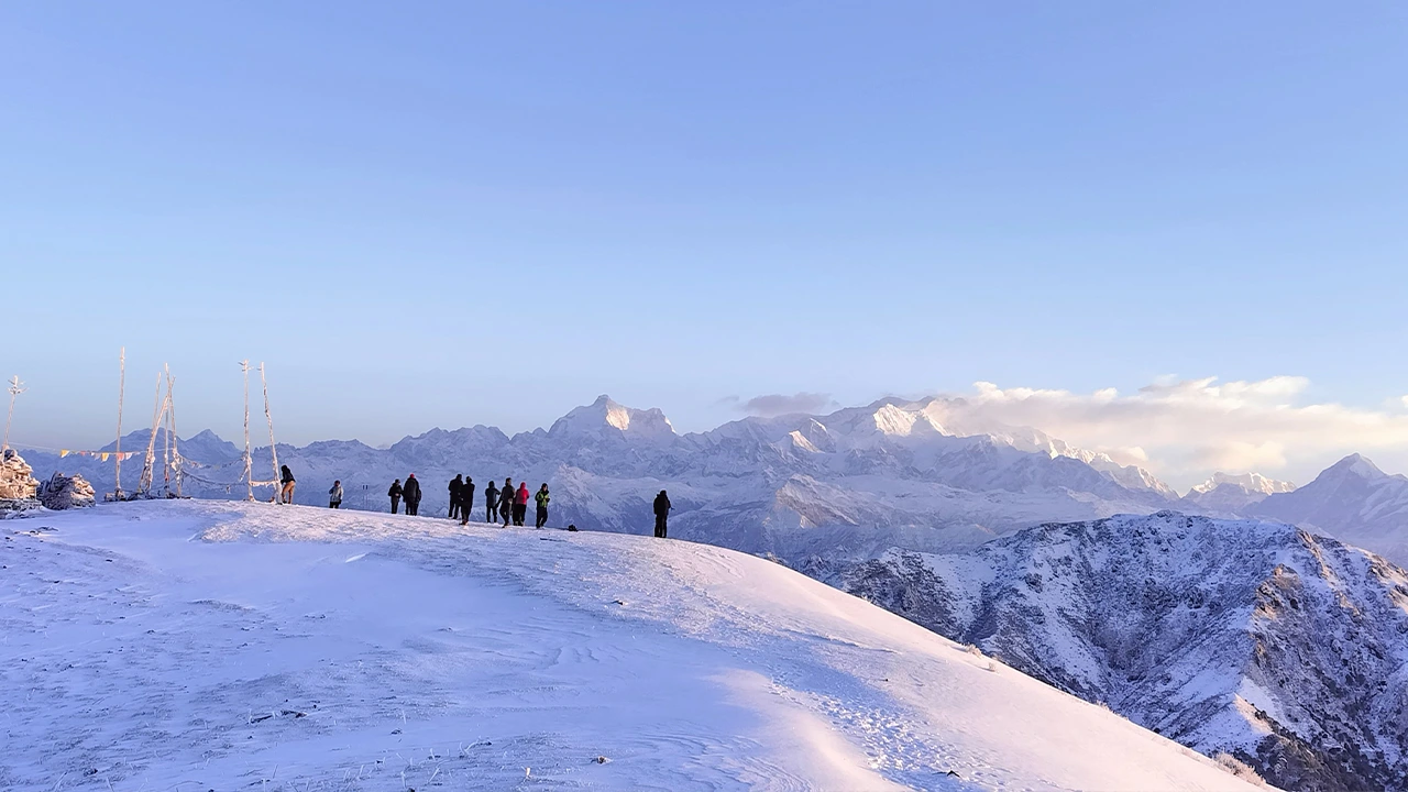 Sanadakphu winter trek on snow-clad trail with panoramic Himalayan mountain view