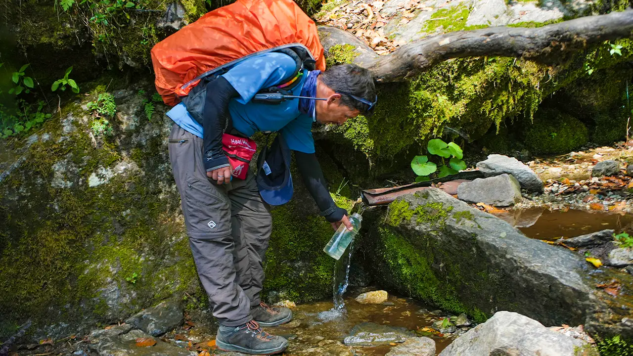Trekker is filling water during a trek