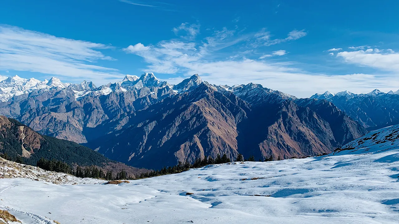 Snowy winter mountains with a stunning peak under clear sky, Trek The Himalayas, hikes of india
